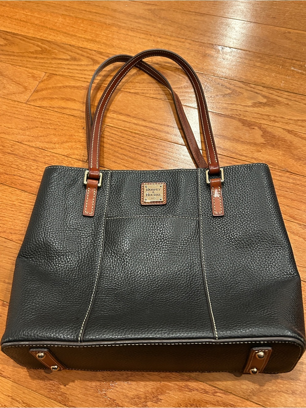 Dooney & Bourke Black Pebbled Leather Tote with Brown Handles and Gold Plaque